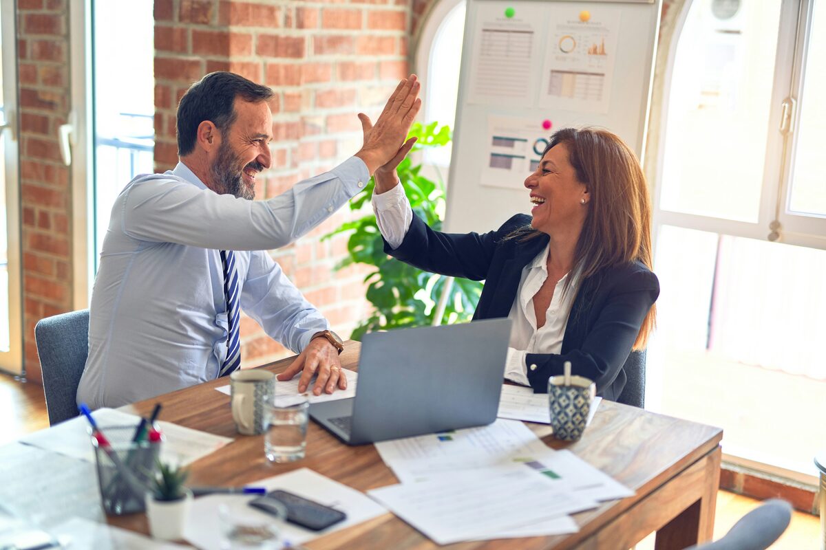 Business partners celebrating successful payment integration